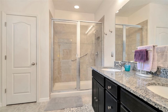 11240 Merganser Way, New Port Richey, FL 34654 - bathroom featuring tile patterned flooring, a stall shower, and double vanity