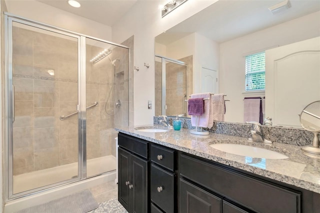 11240 Merganser Way, New Port Richey, FL 34654 - bathroom featuring double vanity, a stall shower, and tile patterned floors