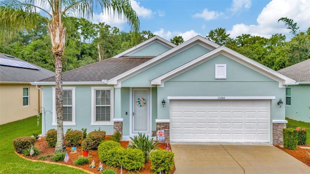 11240 Merganser Way, New Port Richey, FL 34654 - single story home with stone siding, stucco siding, an attached garage, and driveway