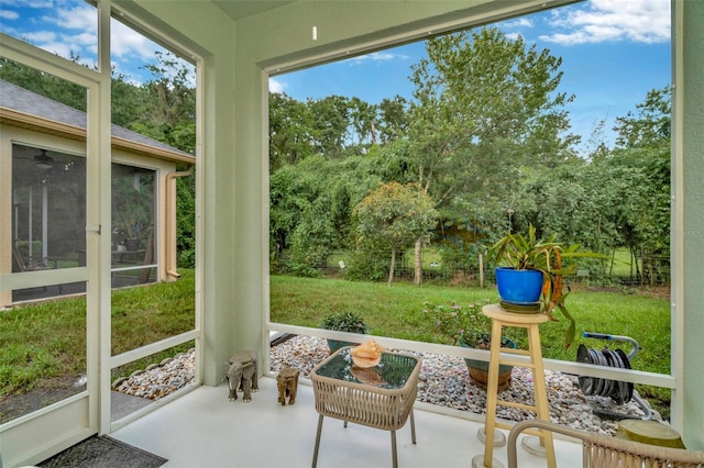 11240 Merganser Way, New Port Richey, FL 34654 - sunroom featuring view of scattered trees