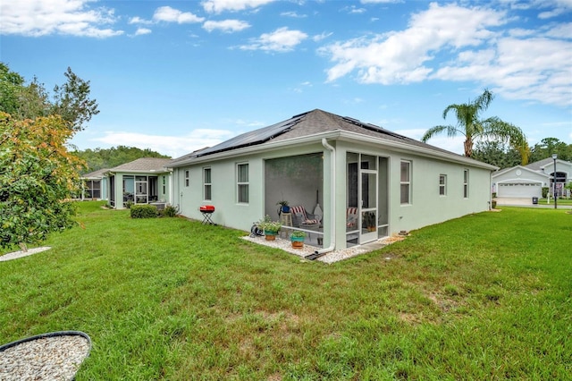 11240 Merganser Way, New Port Richey, FL 34654 - rear view of property with solar panels, a sunroom, stucco siding, and a lawn