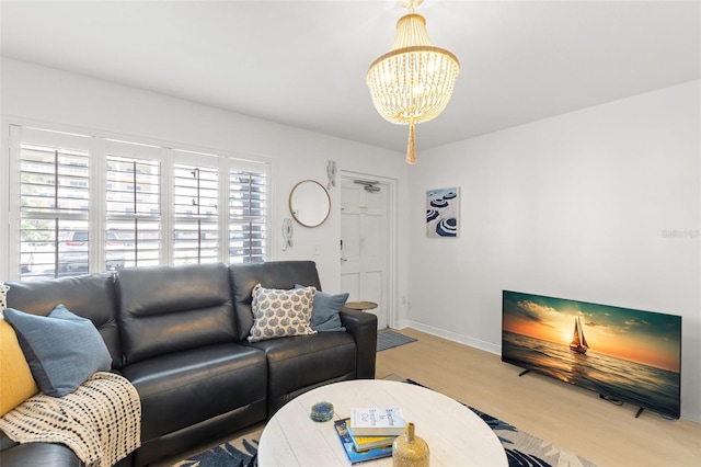 10280 Gulf Blvd Unit 12, Treasure Island, FL 33706 - living room featuring wood finished floors and a chandelier