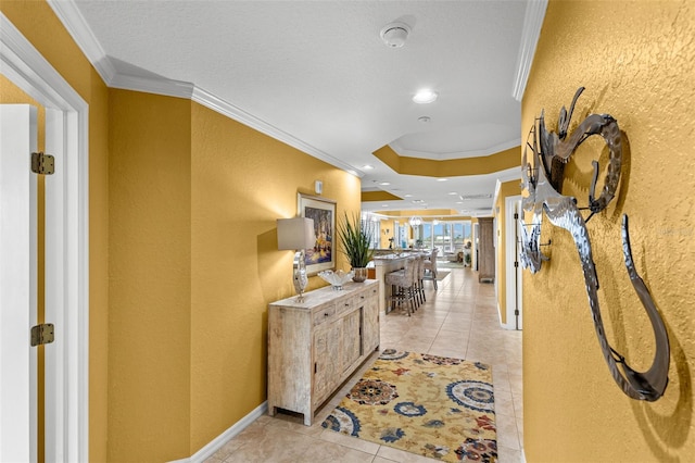 3805 Gulf Blvd Unit 401, St Pete Beach, FL 33706 - hallway featuring ornamental molding, a textured wall, light tile patterned floors, recessed lighting, and a raised ceiling
