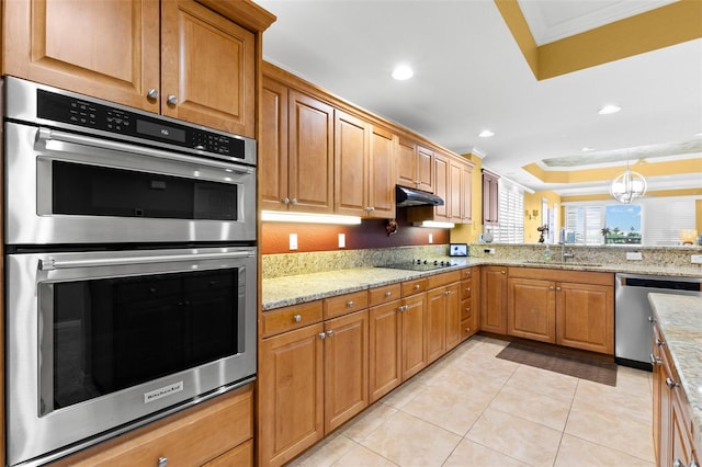 3805 Gulf Blvd Unit 401, St Pete Beach, FL 33706 - kitchen with stainless steel appliances, crown molding, light tile patterned flooring, light stone countertops, and a raised ceiling