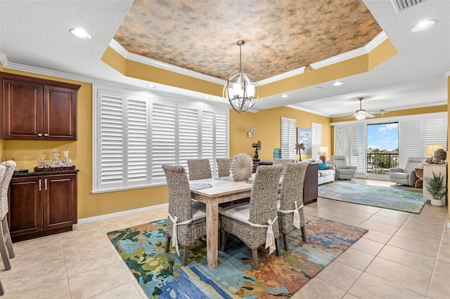 3805 Gulf Blvd Unit 401, St Pete Beach, FL 33706 - dining area with a tray ceiling, crown molding, light tile patterned floors, a chandelier, and a ceiling fan