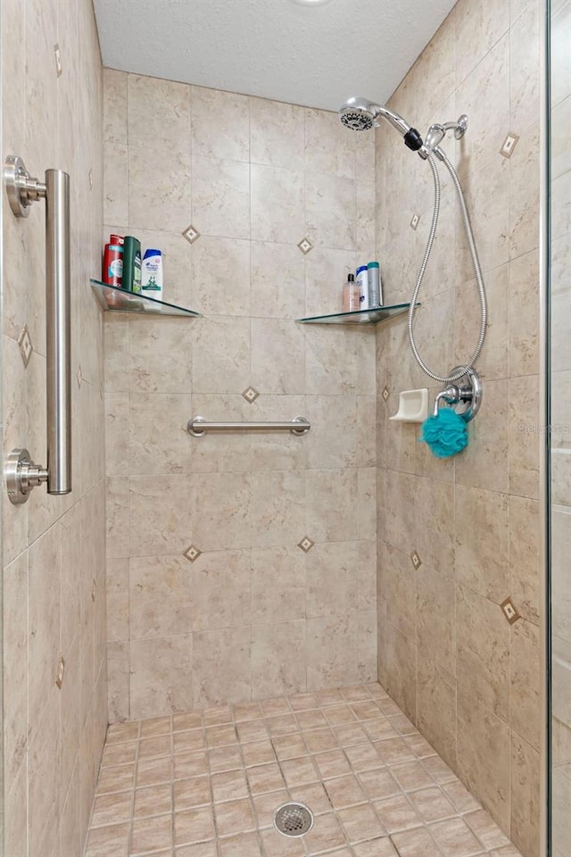 3805 Gulf Blvd Unit 401, St Pete Beach, FL 33706 - full bathroom featuring tiled shower and a textured ceiling