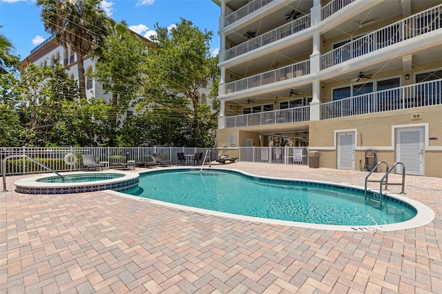3805 Gulf Blvd Unit 401, St Pete Beach, FL 33706 - view of pool featuring a ceiling fan, a patio, and a pool with connected hot tub