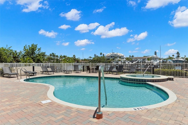 3805 Gulf Blvd Unit 401, St Pete Beach, FL 33706 - view of pool featuring a patio area and a pool with connected hot tub