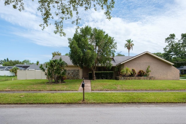 2421 Eagle Chase Dr, Palm Harbor, FL 34683 - view of front of house with stucco siding and a front lawn