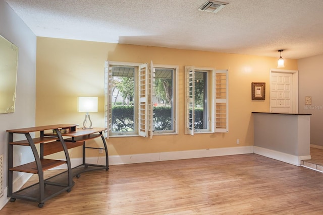 2421 Eagle Chase Dr, Palm Harbor, FL 34683 - empty room featuring wood finished floors and a textured ceiling
