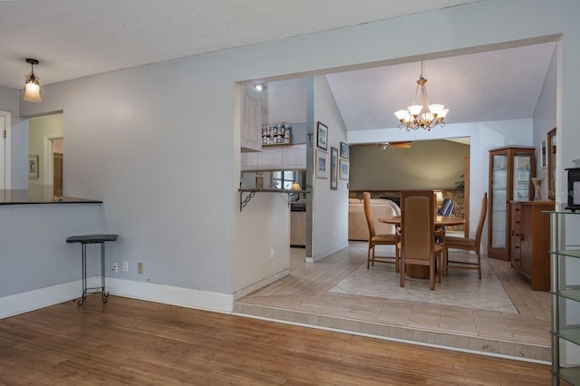 2421 Eagle Chase Dr, Palm Harbor, FL 34683 - dining space with wood finished floors, a chandelier, and a textured ceiling