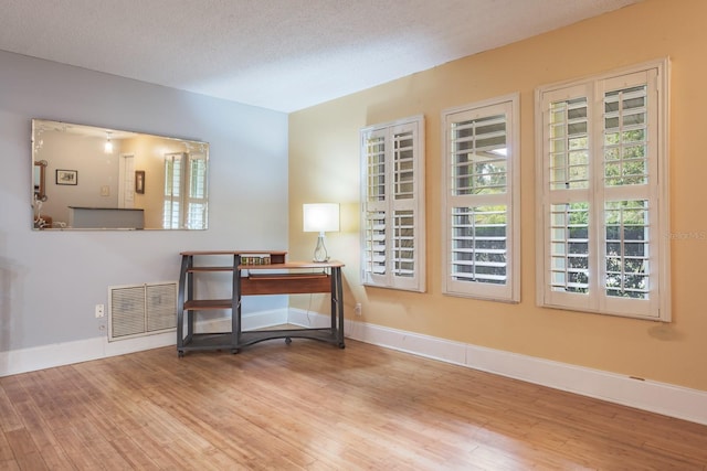 2421 Eagle Chase Dr, Palm Harbor, FL 34683 - sitting room with wood finished floors and a textured ceiling