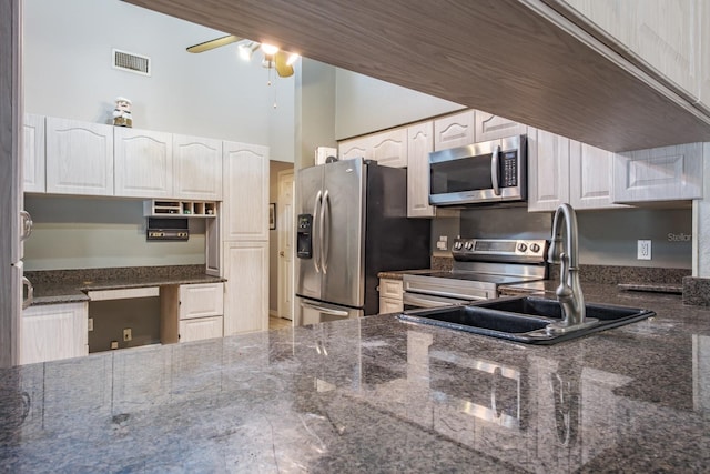 2421 Eagle Chase Dr, Palm Harbor, FL 34683 - kitchen featuring stainless steel appliances, a ceiling fan, dark stone countertops, white cabinets, and a high ceiling
