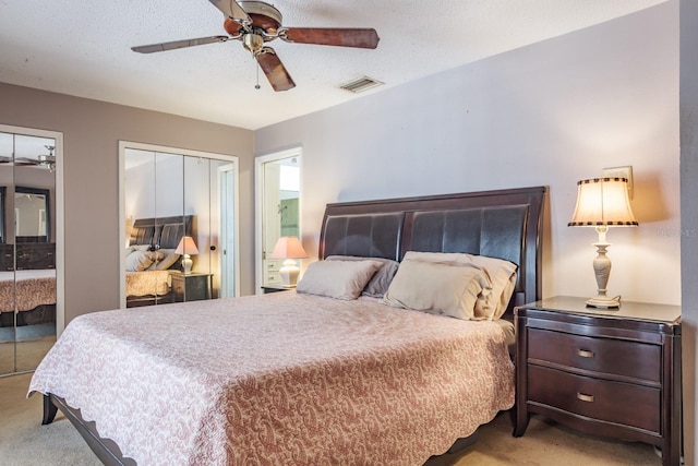 2421 Eagle Chase Dr, Palm Harbor, FL 34683 - carpeted bedroom featuring two closets, a ceiling fan, and a textured ceiling