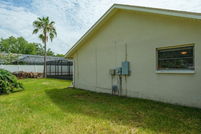 2421 Eagle Chase Dr, Palm Harbor, FL 34683 - view of home's exterior featuring glass enclosure and stucco siding