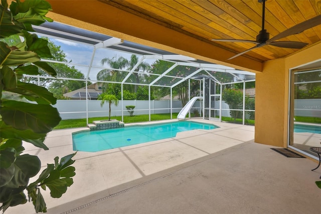 12305 Freesia Ct, Riverview, FL 33569 - view of swimming pool featuring a fenced backyard, a patio area, a water slide, ceiling fan, and a lanai