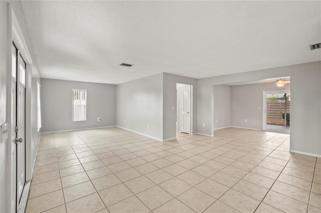7108 14th Ave NW, Bradenton, FL 34209 - unfurnished room featuring a textured ceiling, light tile patterned flooring, and ceiling fan