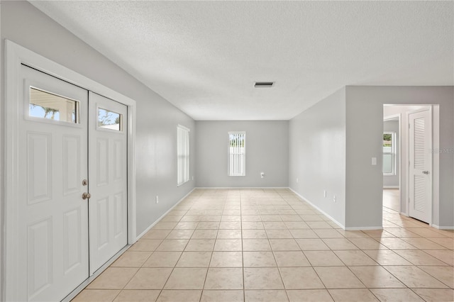 7108 14th Ave NW, Bradenton, FL 34209 - entrance foyer featuring light tile patterned floors and a textured ceiling