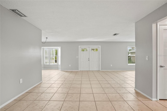 7108 14th Ave NW, Bradenton, FL 34209 - spare room featuring healthy amount of natural light and light tile patterned floors