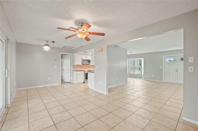 7108 14th Ave NW, Bradenton, FL 34209 - unfurnished living room featuring ceiling fan, light tile patterned floors, and a textured ceiling