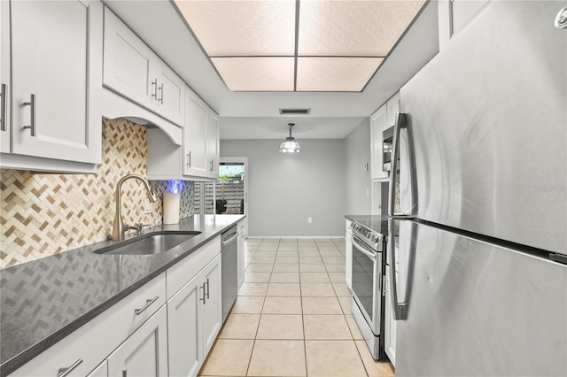 7108 14th Ave NW, Bradenton, FL 34209 - kitchen featuring stainless steel appliances, decorative backsplash, and white cabinets