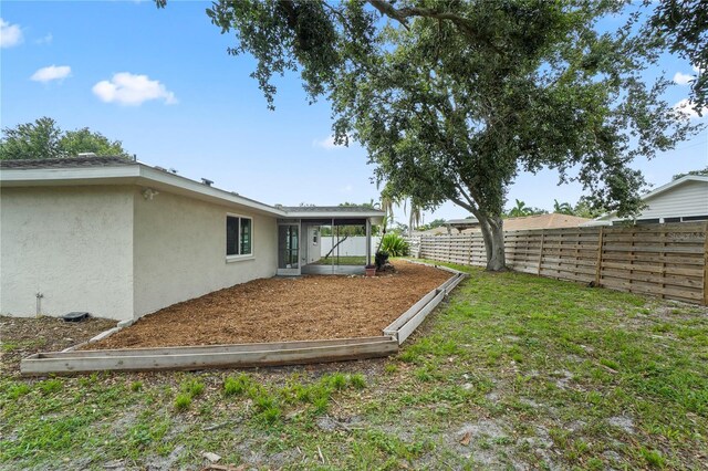 7108 14th Ave NW, Bradenton, FL 34209 - fenced backyard featuring a sunroom