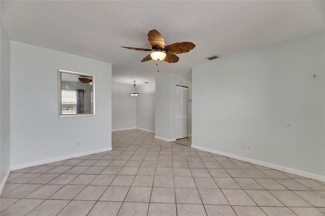1049 Apollo Beach Blvd Unit D, Apollo Beach, FL 33572 - empty room with ceiling fan, a textured ceiling, and light tile patterned floors