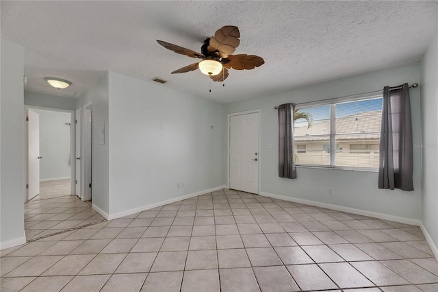 1049 Apollo Beach Blvd Unit D, Apollo Beach, FL 33572 - spare room featuring light tile patterned floors, a textured ceiling, and ceiling fan