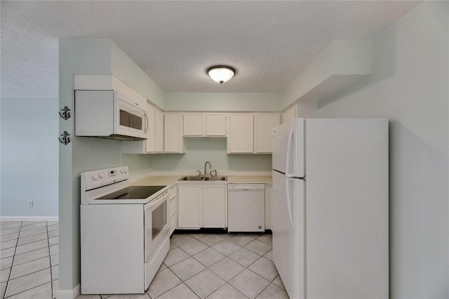 1049 Apollo Beach Blvd Unit D, Apollo Beach, FL 33572 - kitchen with white appliances, light tile patterned floors, a textured ceiling, light countertops, and white cabinetry