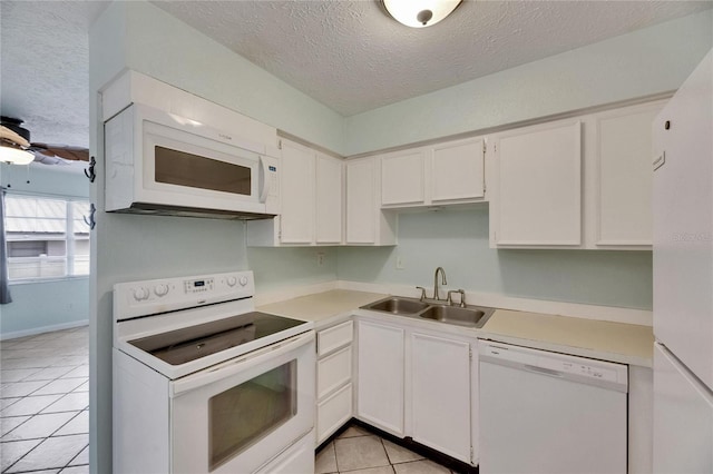 1049 Apollo Beach Blvd Unit D, Apollo Beach, FL 33572 - kitchen with white appliances, a textured ceiling, light countertops, light tile patterned flooring, and white cabinetry