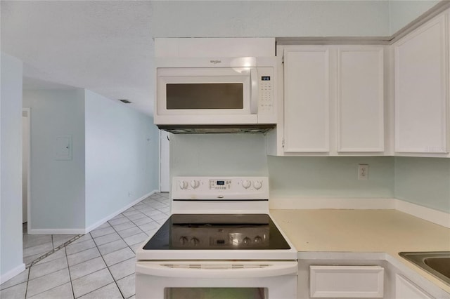 1049 Apollo Beach Blvd Unit D, Apollo Beach, FL 33572 - kitchen with white appliances, white cabinetry, light tile patterned floors, and light countertops
