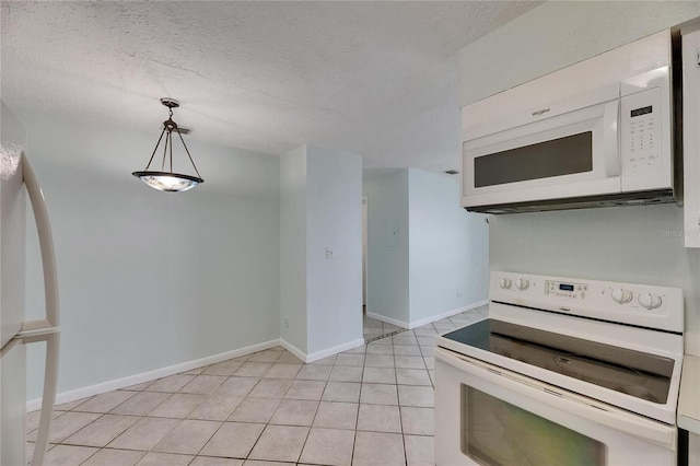 1049 Apollo Beach Blvd Unit D, Apollo Beach, FL 33572 - kitchen with white appliances, light tile patterned flooring, a textured ceiling, and hanging light fixtures