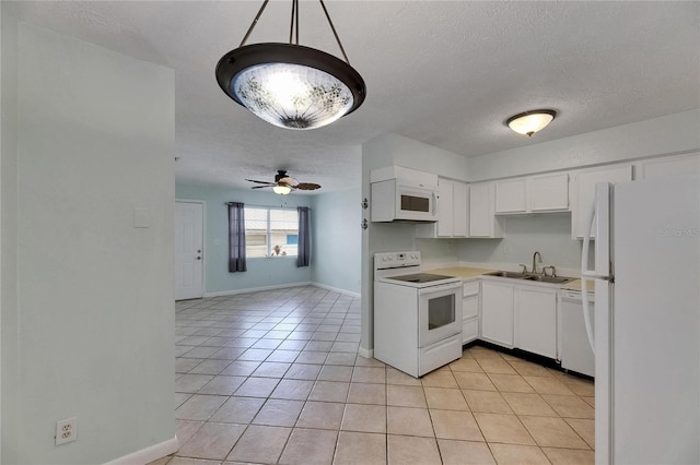 1049 Apollo Beach Blvd Unit D, Apollo Beach, FL 33572 - kitchen with white appliances, a textured ceiling, light tile patterned floors, white cabinetry, and light countertops