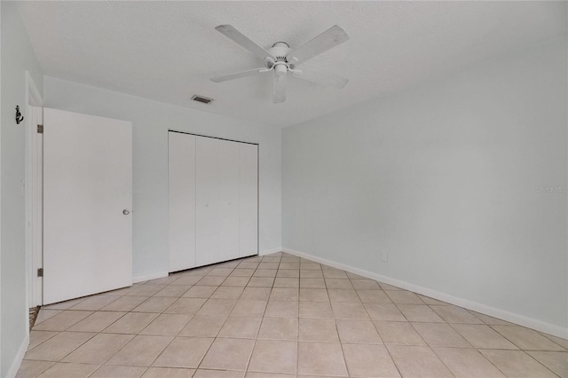 1049 Apollo Beach Blvd Unit D, Apollo Beach, FL 33572 - unfurnished bedroom featuring a closet, a ceiling fan, and light tile patterned flooring