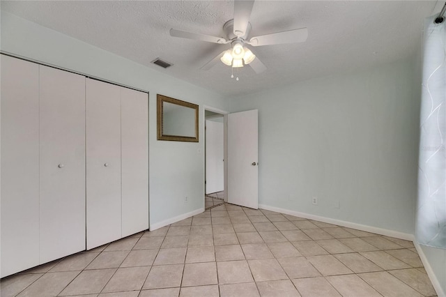 1049 Apollo Beach Blvd Unit D, Apollo Beach, FL 33572 - unfurnished bedroom with a textured ceiling, a closet, and a ceiling fan