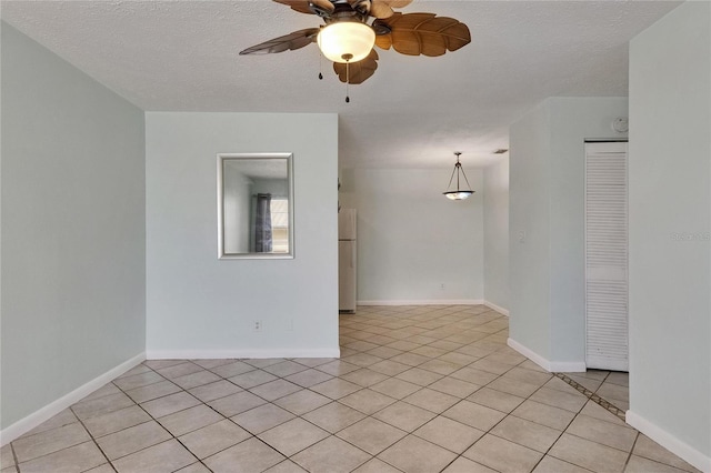 1049 Apollo Beach Blvd Unit D, Apollo Beach, FL 33572 - empty room featuring a ceiling fan, light tile patterned flooring, and a textured ceiling
