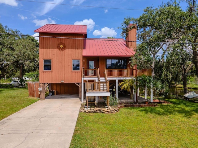 9501 Alice Ln, Riverview, FL 33578 - rustic home featuring a carport, driveway, a metal roof, a chimney, and a standing seam roof