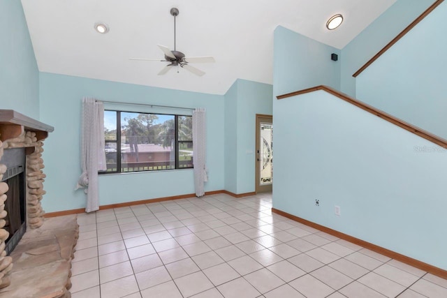 9501 Alice Ln, Riverview, FL 33578 - unfurnished living room with ceiling fan, a stone fireplace, light tile patterned flooring, and high vaulted ceiling