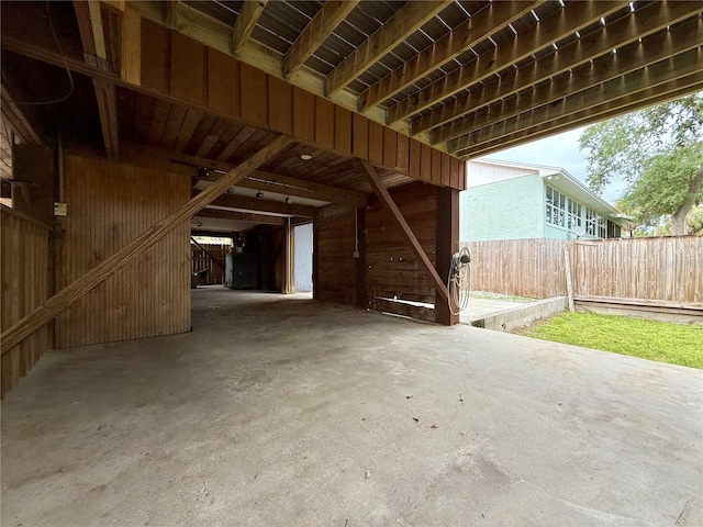 9501 Alice Ln, Riverview, FL 33578 - misc room featuring unfinished concrete flooring and wooden walls