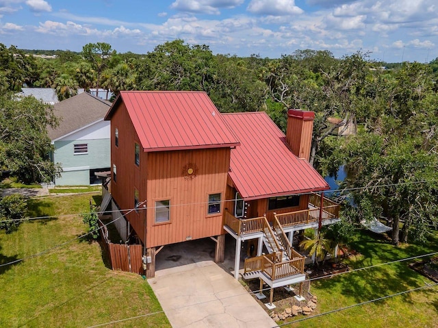 9501 Alice Ln, Riverview, FL 33578 - view of front of property featuring a metal roof, a front yard, and concrete driveway
