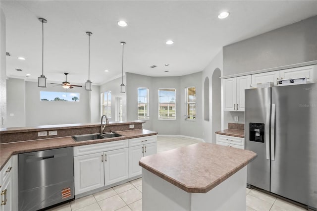 11810 Holly Creek Dr, Riverview, FL 33569 - kitchen featuring appliances with stainless steel finishes, light tile patterned flooring, recessed lighting, white cabinets, and pendant lighting