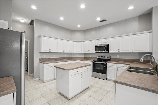 11810 Holly Creek Dr, Riverview, FL 33569 - kitchen featuring stainless steel appliances, light tile patterned flooring, white cabinets, and recessed lighting