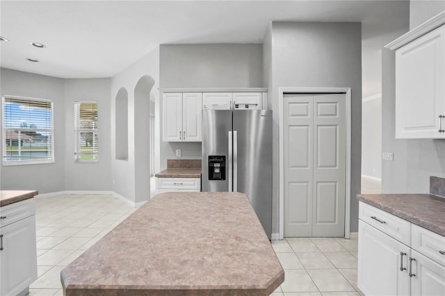 11810 Holly Creek Dr, Riverview, FL 33569 - kitchen with light tile patterned floors, a center island, white cabinets, stainless steel fridge with ice dispenser, and recessed lighting