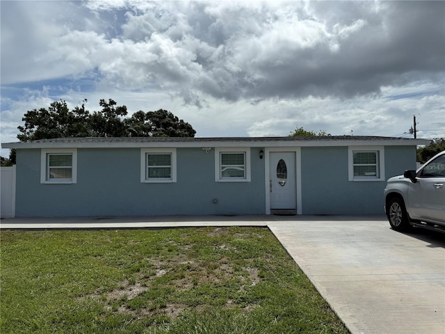 2927 W Henry Ave, Tampa, FL 33614 - ranch-style house with stucco siding and a front yard