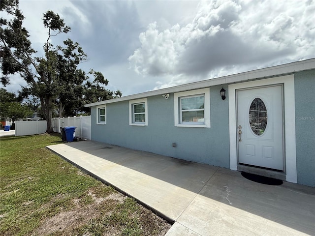2927 W Henry Ave, Tampa, FL 33614 - entrance to property featuring stucco siding and a patio
