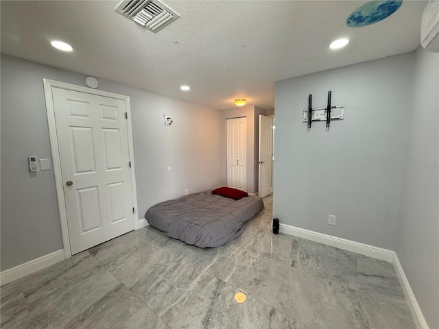 2927 W Henry Ave, Tampa, FL 33614 - bedroom featuring marble finish flooring, recessed lighting, a closet, and a textured ceiling