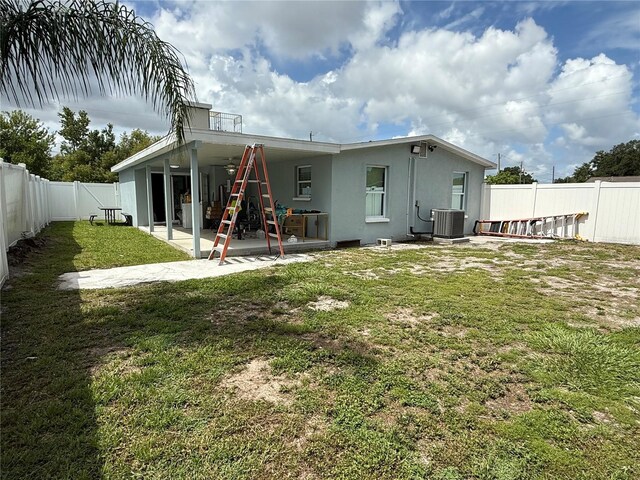 2927 W Henry Ave, Tampa, FL 33614 - rear view of house with stucco siding, a patio area, and a fenced backyard