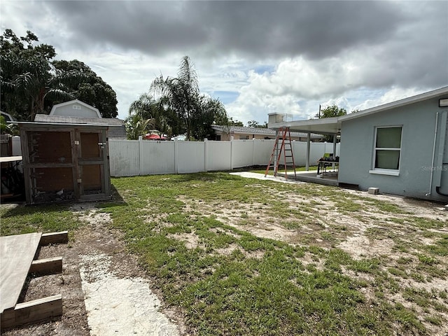 2927 W Henry Ave, Tampa, FL 33614 - fenced backyard with a storage shed and a patio area