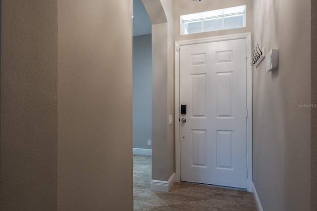 3298 Covered Bridge Dr W, Dunedin, FL 34698 - entrance foyer featuring wood finished floors and arched walkways