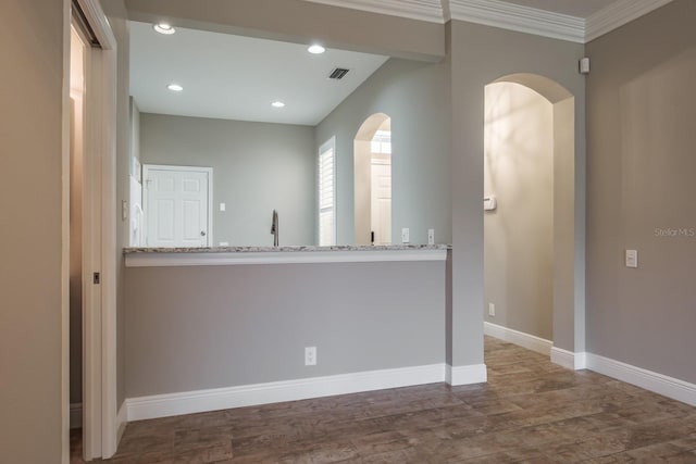 3298 Covered Bridge Dr W, Dunedin, FL 34698 - empty room with arched walkways, wood finished floors, ornamental molding, and recessed lighting
